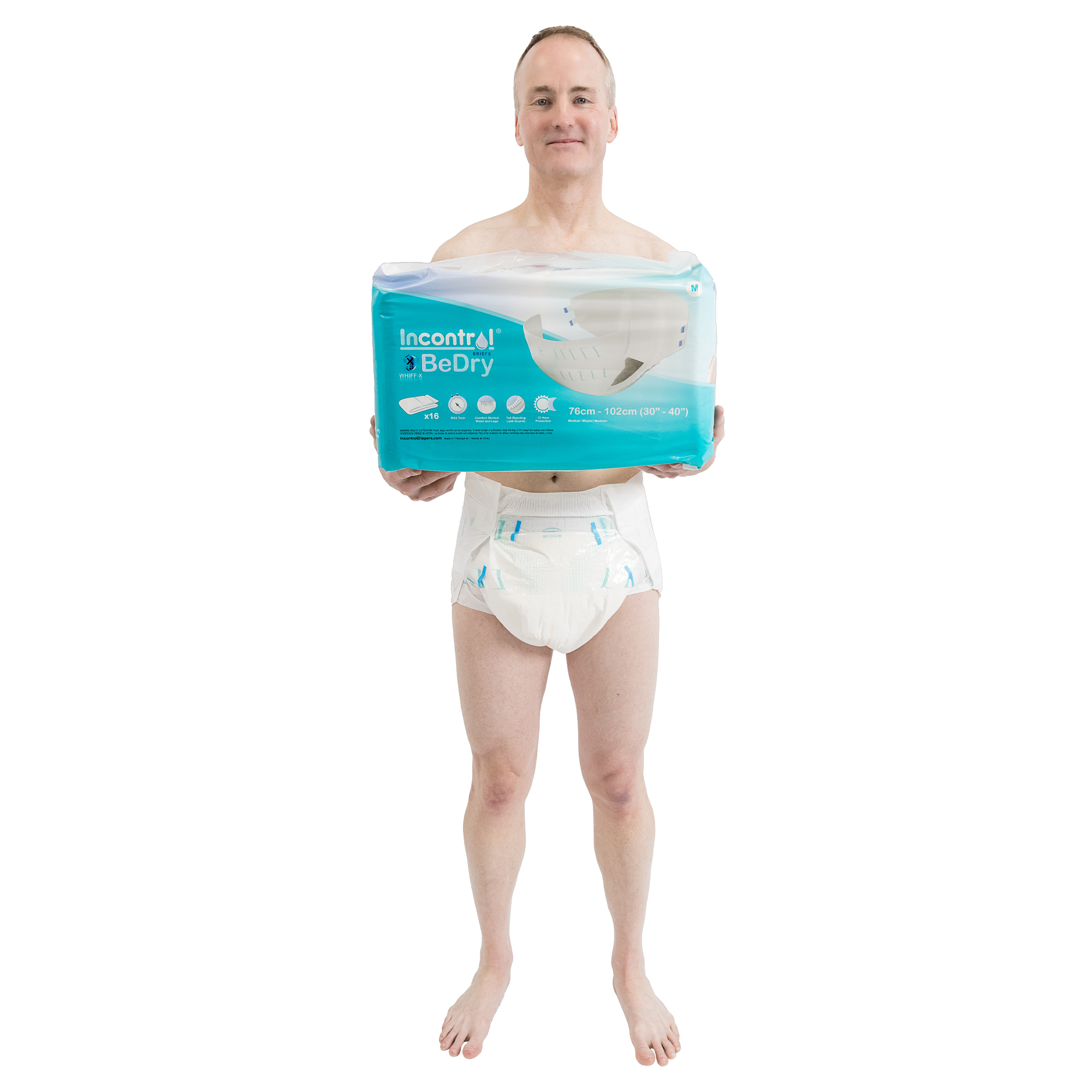 male model wearing BeDry diaper and holding bag of diapers